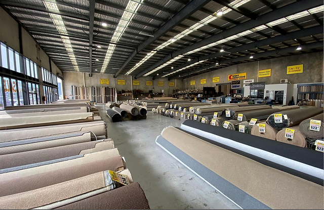 Carpet rolls displayed inside the warehouse